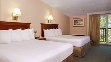 A hotel room with two beds, a nightstand, a phone, a painting on the wall, and a balcony with curtains.