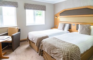A hotel room with two beds, a desk, and a chair. - Fairlawns Hotel and Spa (Walsall)