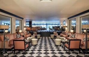 A hotel lobby with a checkered floor, sofas, armchairs, and lamps. - Leonardo Royal Hotel Bristol - formerly The Bristol Hotel (Bristol)
