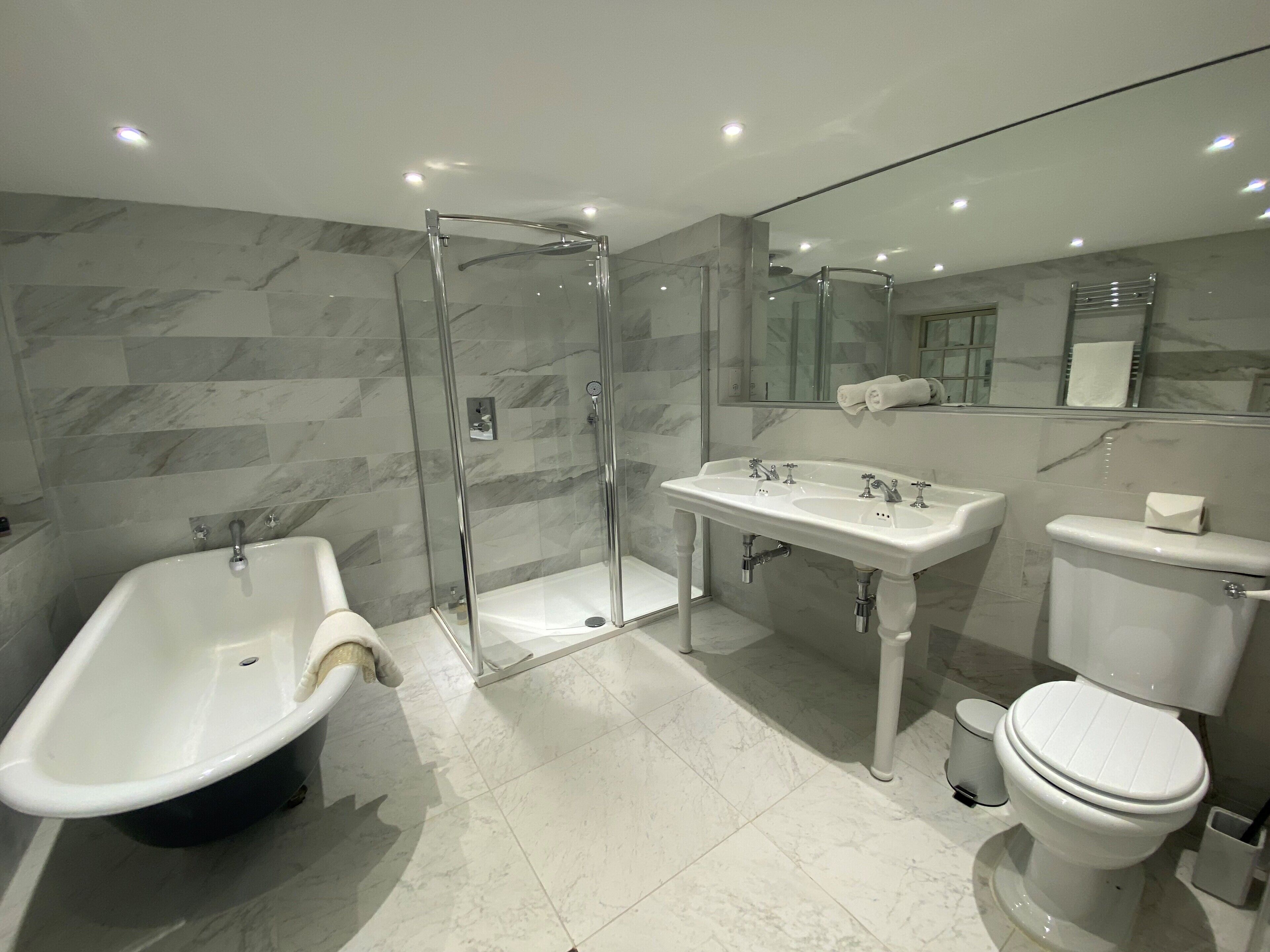 junior suite | bathroom | shower, free toiletries, hair dryer, bathrobes