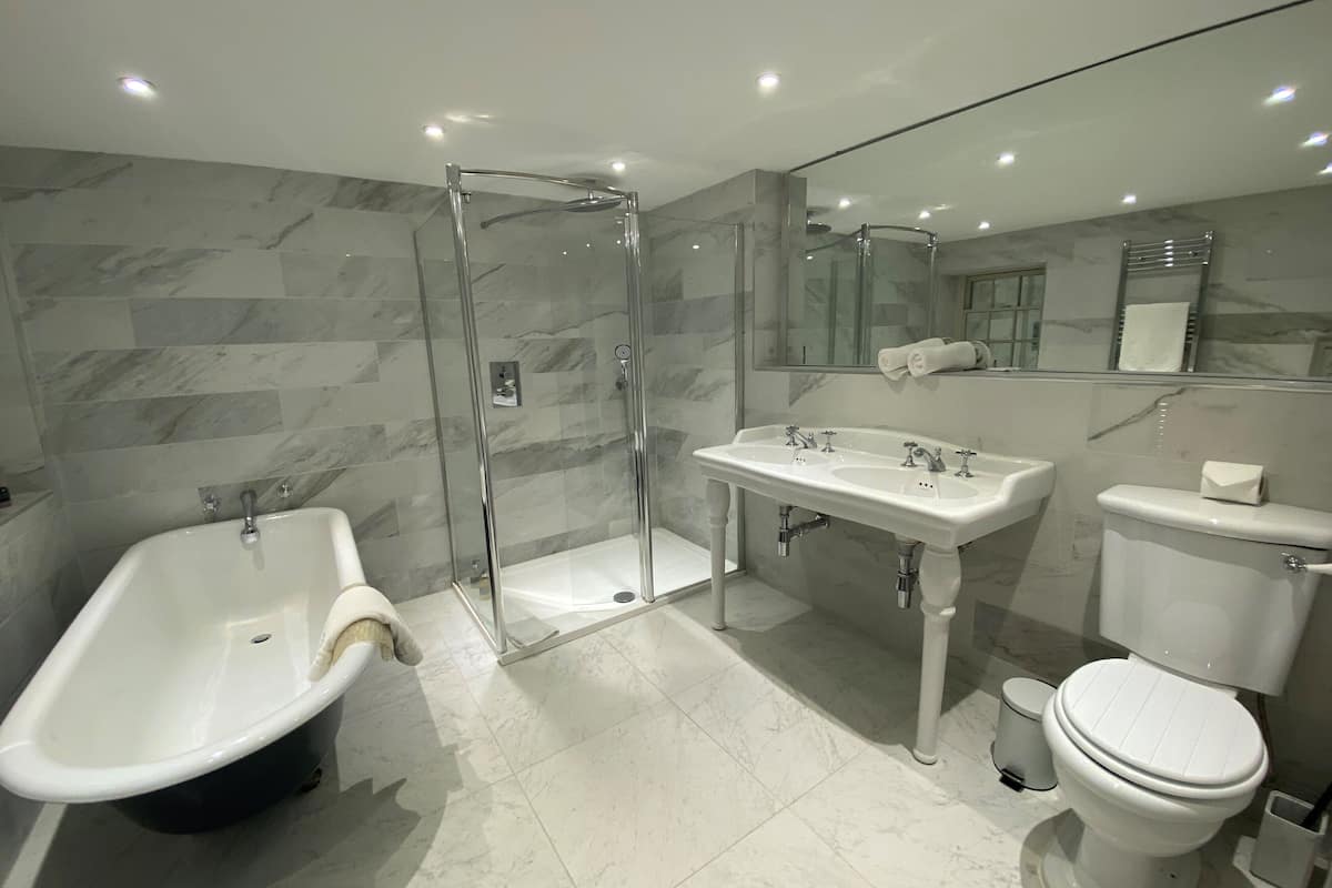 junior suite | bathroom | shower, free toiletries, hair dryer, bathrobes