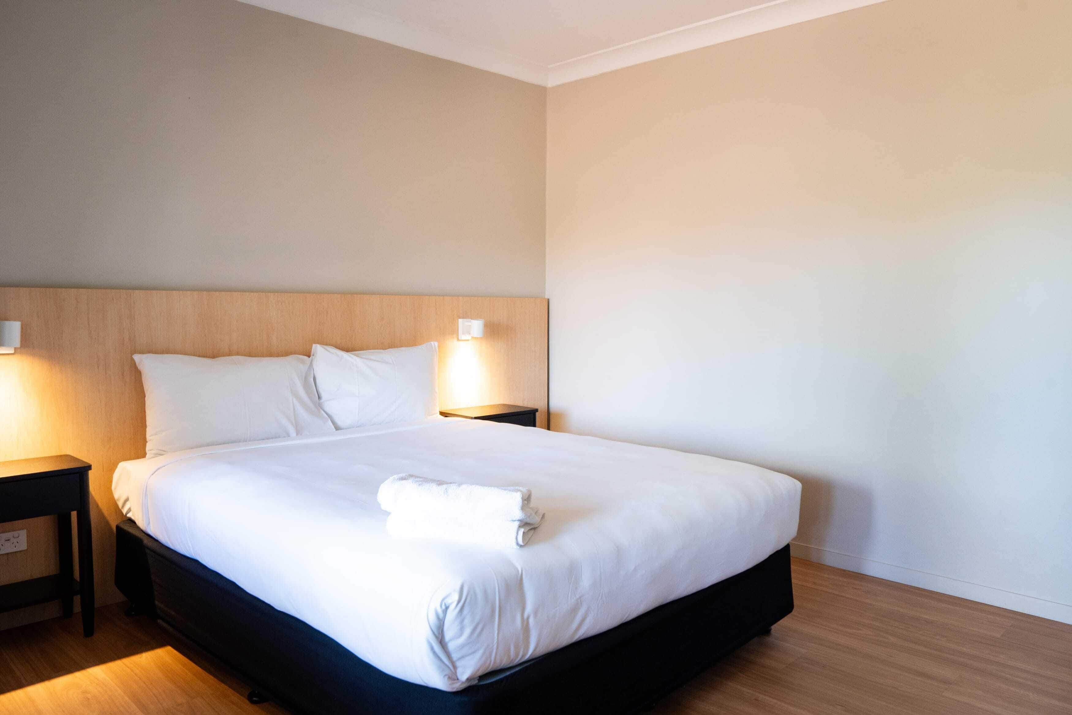 Desk, laptop workspace, iron/ironing board, bed sheets