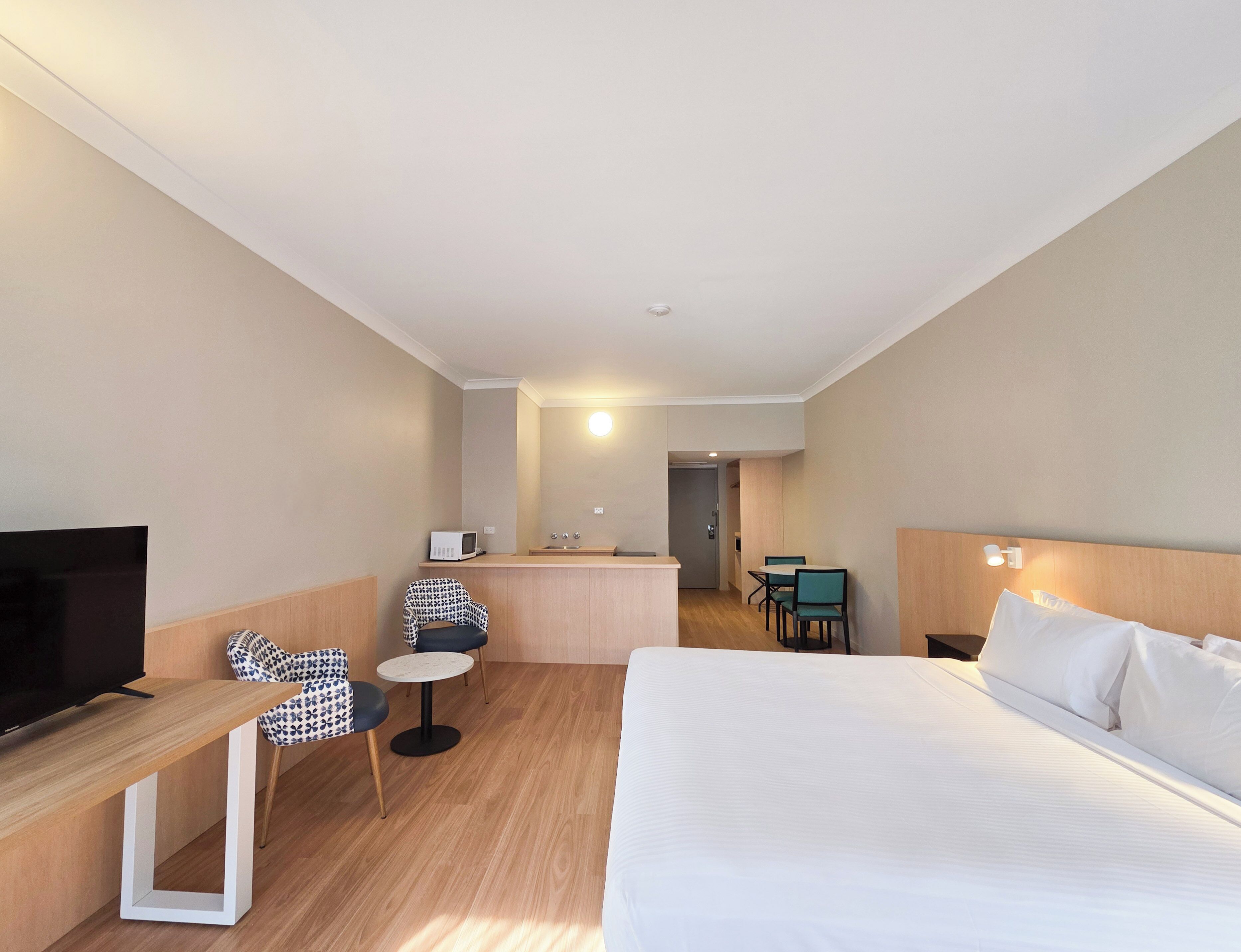 Desk, laptop workspace, iron/ironing board, bed sheets