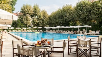 Seasonal outdoor pool, open 10:00 AM to 6:00 PM, pool umbrellas