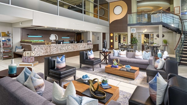A spacious lobby with a reception desk, seating area, and a staircase. - DoubleTree by Hilton Hotel Chattanooga Downtown (Chattanooga)