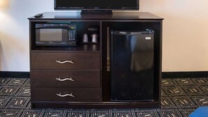 A compact minibar with a television, microwave, and refrigerator. - Quality Inn Brooklyn Center (Brooklyn Center)
