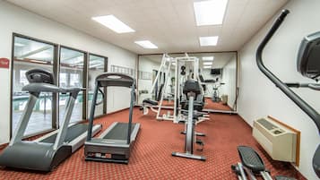 A gym with treadmills, elliptical machines, and weight equipment.