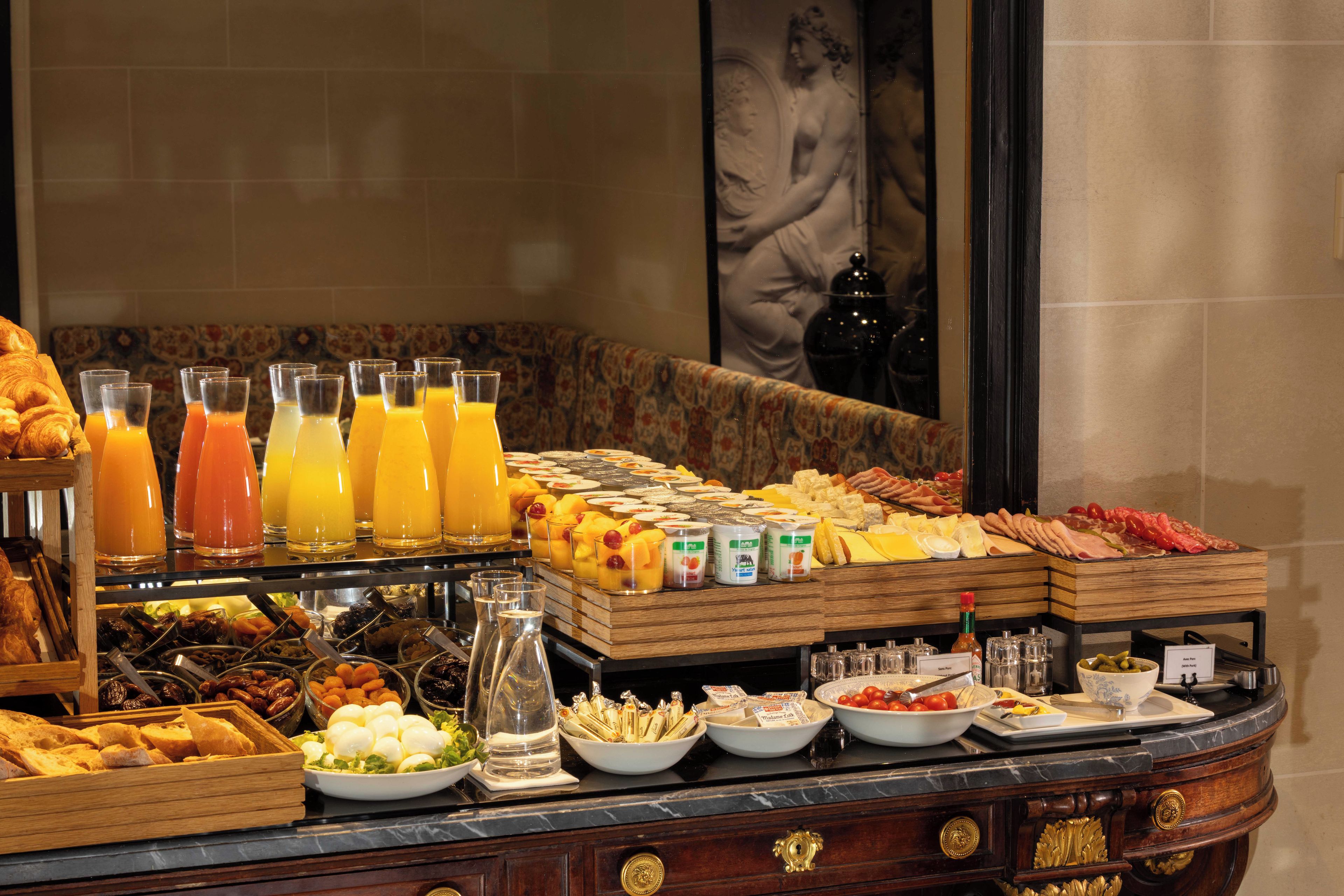 A breakfast buffet with various food items and beverages.