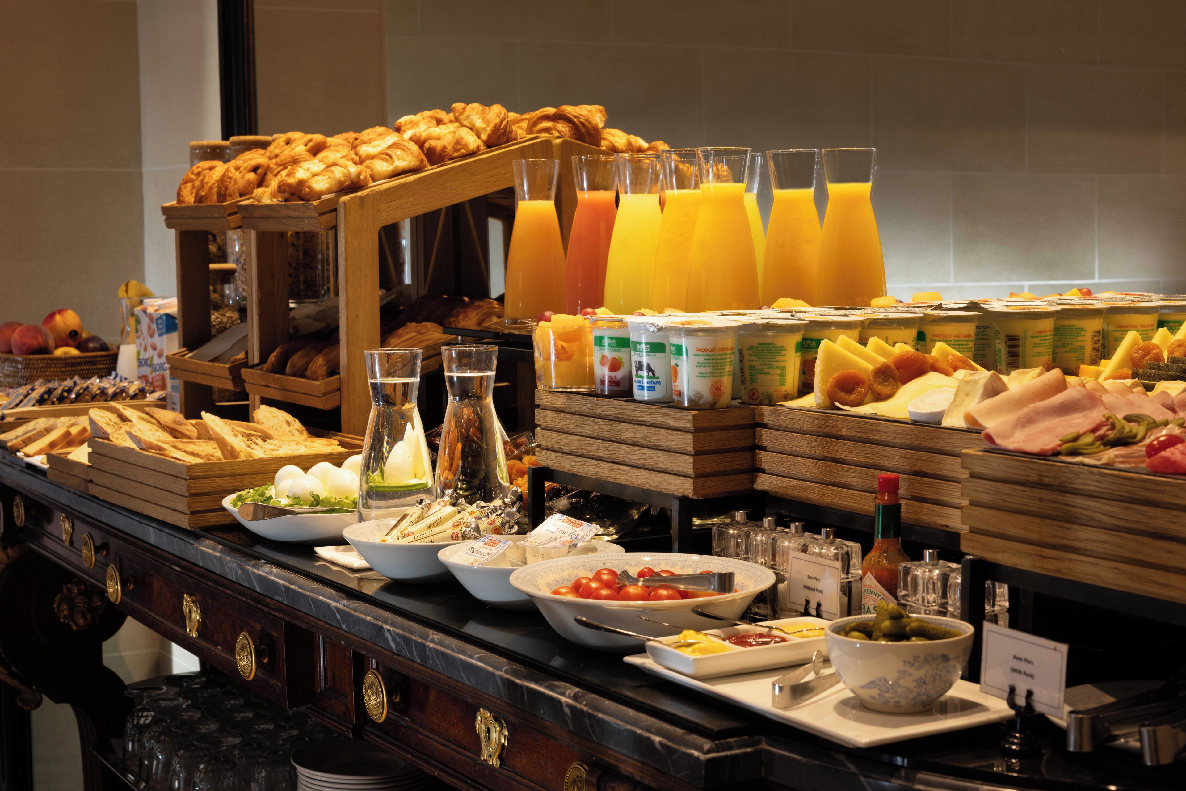 A buffet with various food items and beverages.