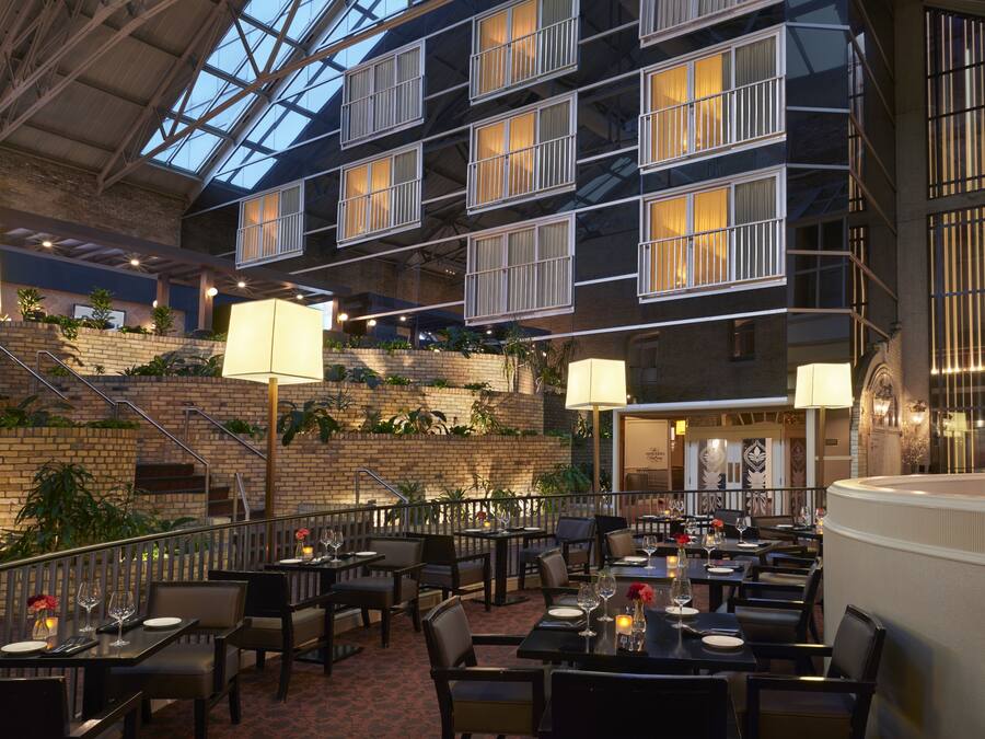 A multi-level dining area with tables, chairs, and a staircase.