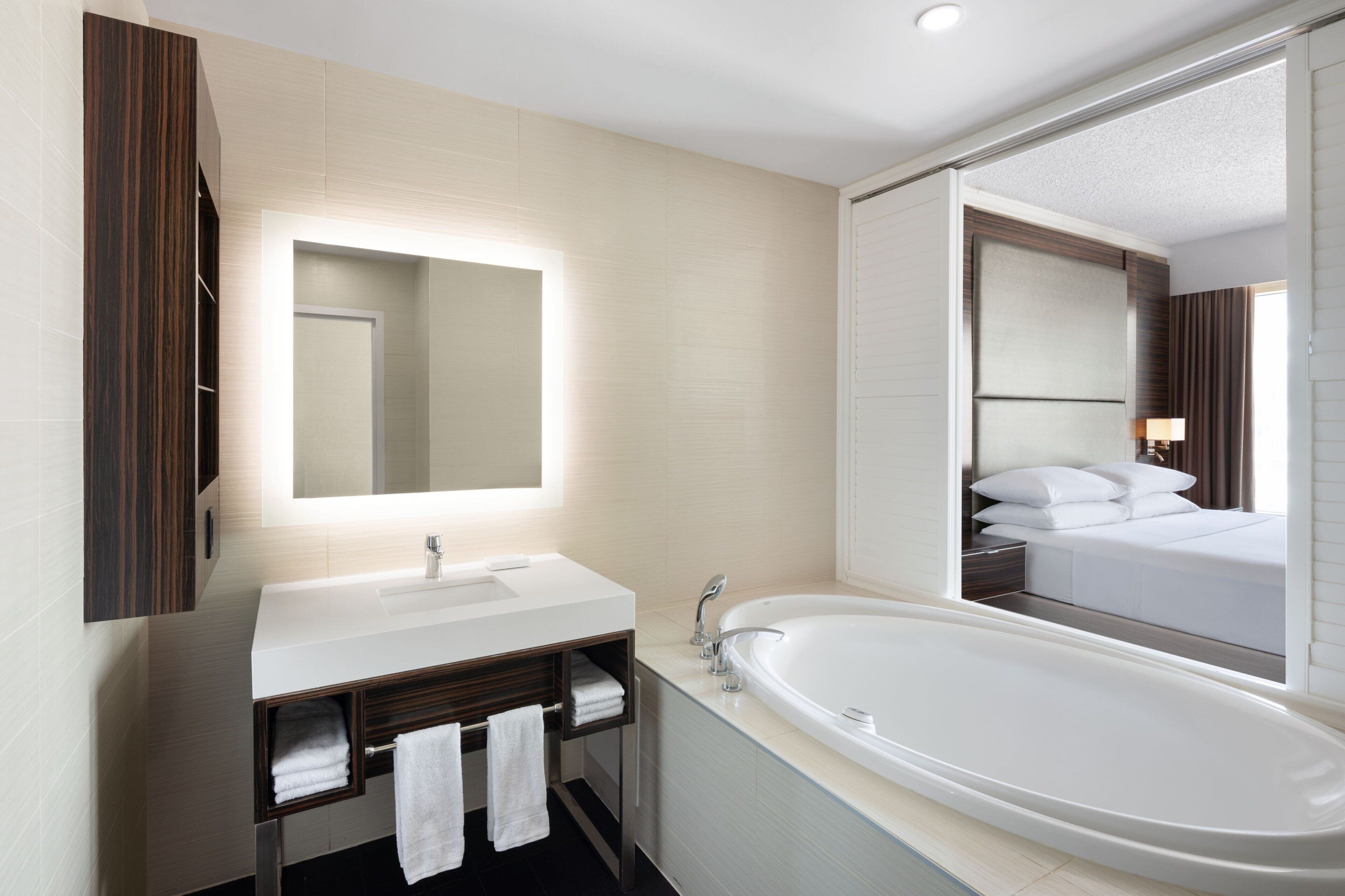 combined shower/bathtub, designer toiletries, hair dryer, towels