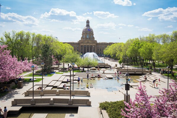 A public square with a fountain, seating areas, and a large building with a dome in the background. - Delta Hotels by Marriott Edmonton Centre Suites (Edmonton)