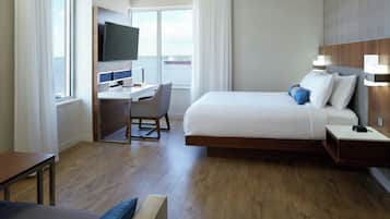 Premium bedding, desk, laptop workspace, blackout curtains