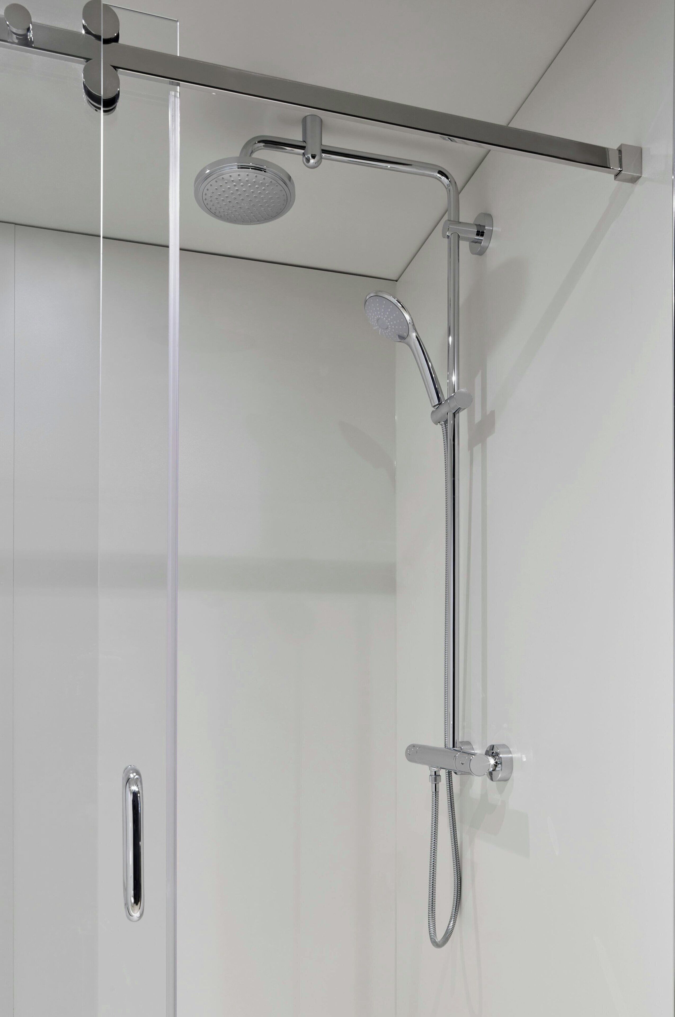 A modern shower enclosure with a handheld showerhead and a fixed showerhead.