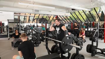 A gym with various exercise equipment, including weight machines and free weights.