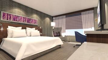 Una habitación de hotel moderna con una cama grande, un escritorio y un televisor.