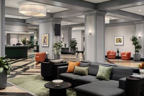 A modern lobby with a reception desk, seating area, and artwork on the walls. - Chelsea Hotel, Toronto (Toronto)