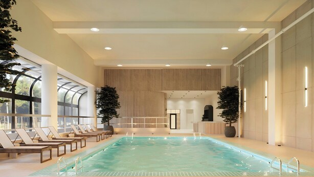 An indoor swimming pool with lounge chairs, large windows, and potted plants. - Chelsea Hotel, Toronto (Toronto)
