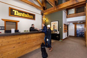 A reception area with a wooden reception desk, a sign reading "Tantalus," and a framed picture on the wall.