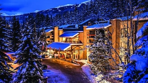 A lodge with multiple buildings, a snow-covered landscape, and a mountain in the background. - Tantalus Resort Lodge (Whistler)