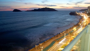 A coastal cityscape with a promenade along the waterfront, featuring a clear view of the sea and distant islands. - Don Pelayo Pacific Beach (Mazatlán)