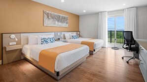 A hotel room with two beds, a desk, and a view of the outdoors. - Days Inn by Wyndham Riviere-Du-Loup (Rivière-du-Loup)