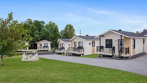 A row of modern mobile homes with a paved driveway and grassy areas. - Days Inn by Wyndham Riviere-Du-Loup (Rivière-du-Loup)