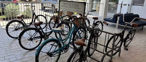 A bicycle rack with a sign indicating it's for hotel guests only.
