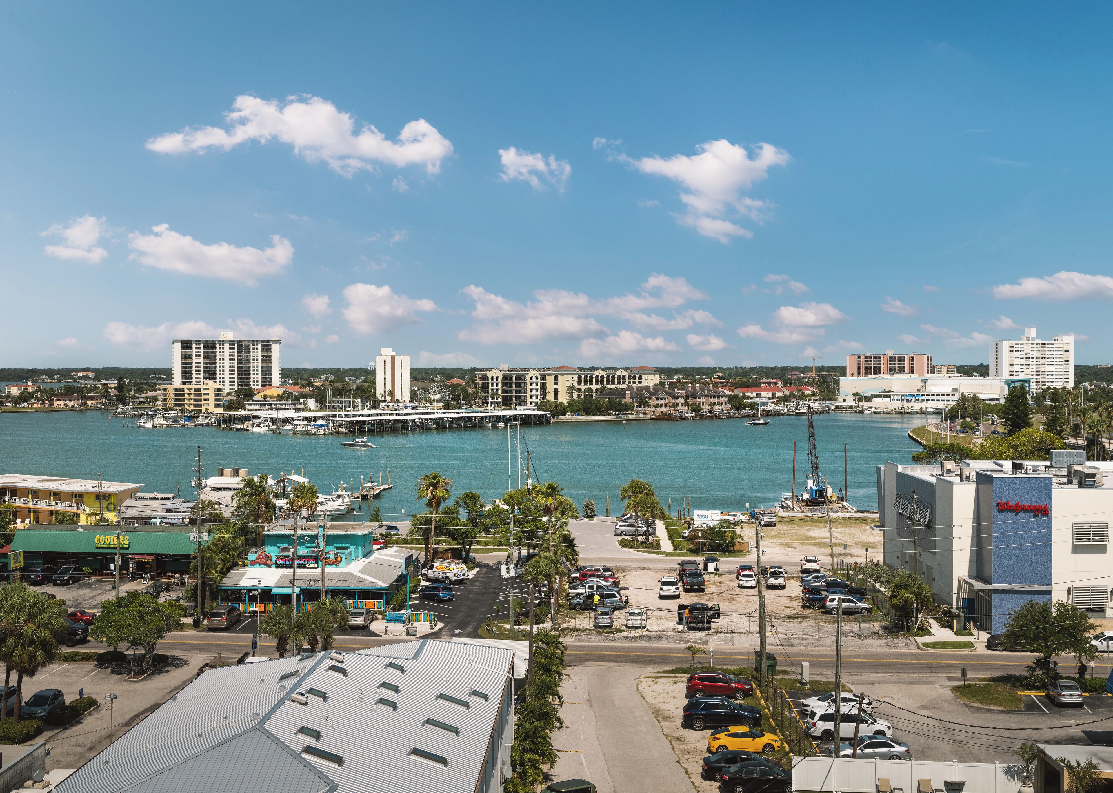 A marina with boats, a waterfront view, and buildings in the background.