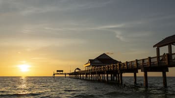 A pier extending into the water with a building at the end.