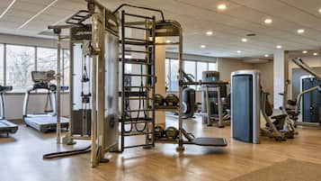 A gym with treadmills, weight machines, and free weights.