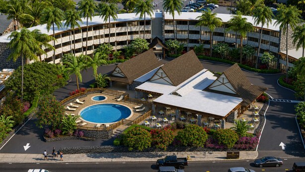 A hotel with a pool, outdoor seating, and a curved building structure.