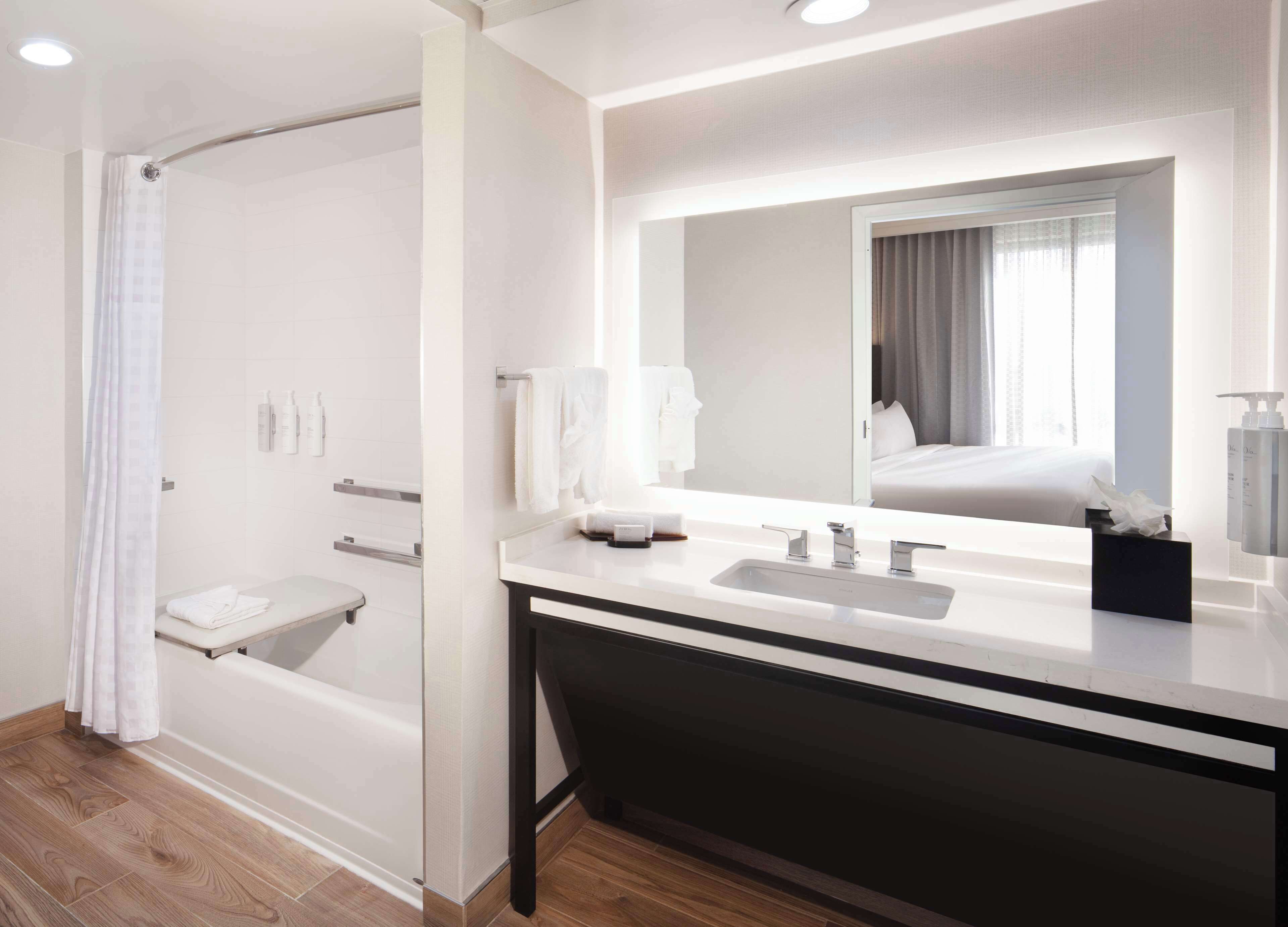 combined shower/bathtub, designer toiletries, hair dryer, towels