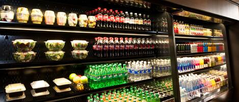 A refrigerated display case with various food items and beverages.