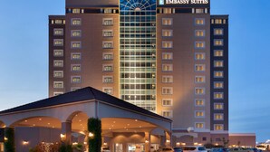 A multi-story hotel with a prominent glass facade and a sign reading "EMBASSY SUITES". - Embassy Suites by Hilton Monterey Bay Seaside (Seaside)