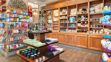 A store with shelves of various items, including hats, plush toys, and books.
