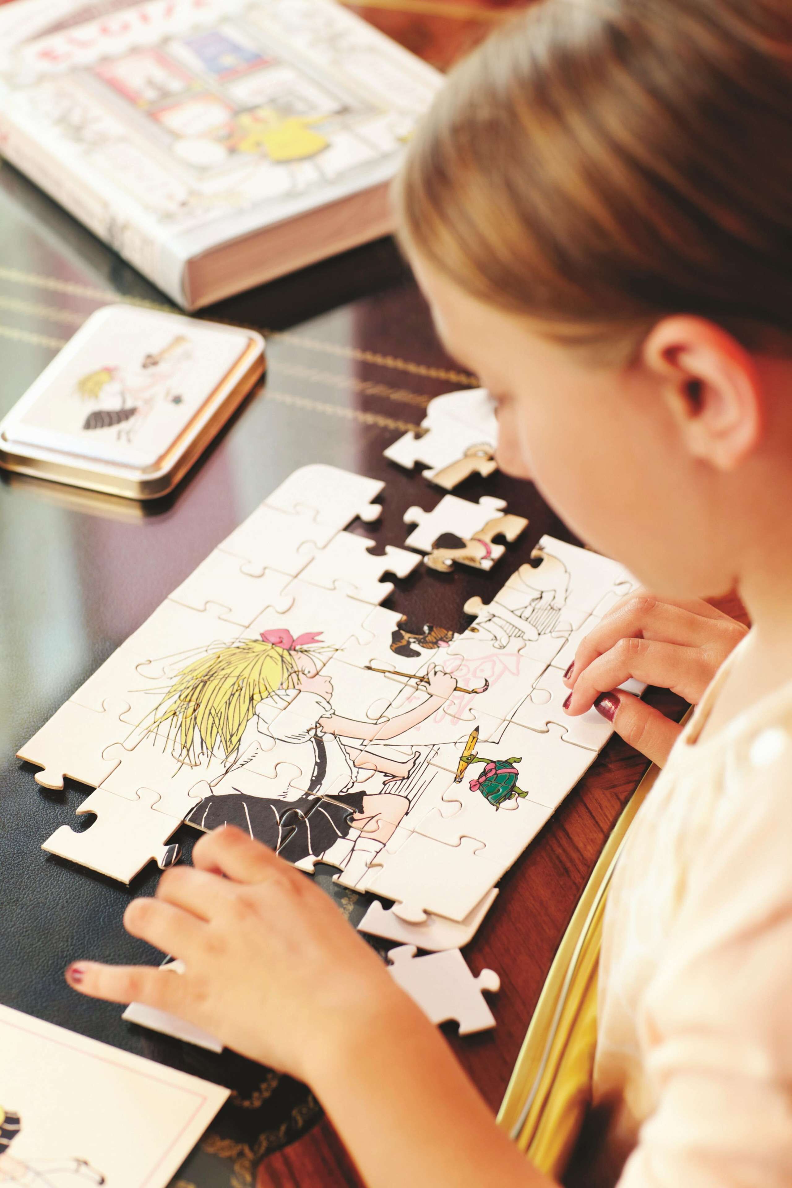 A person assembling a jigsaw puzzle on a table.