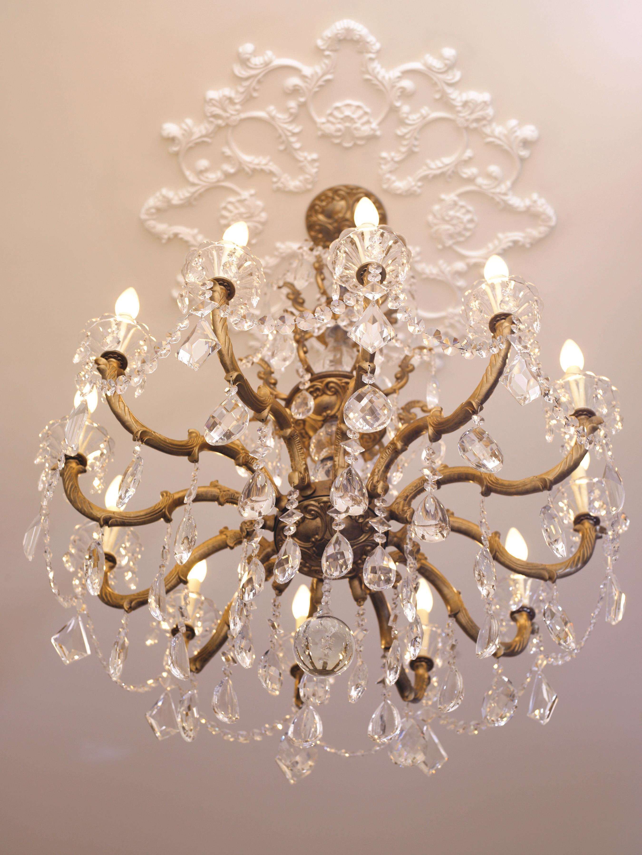A chandelier with multiple arms and crystal decorations.