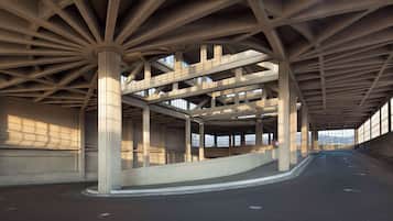 An architectural structure with a series of columns and beams, a curved walkway, and large windows allowing natural light.