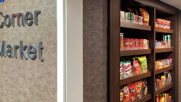 A snack display in a store with various packaged snacks.