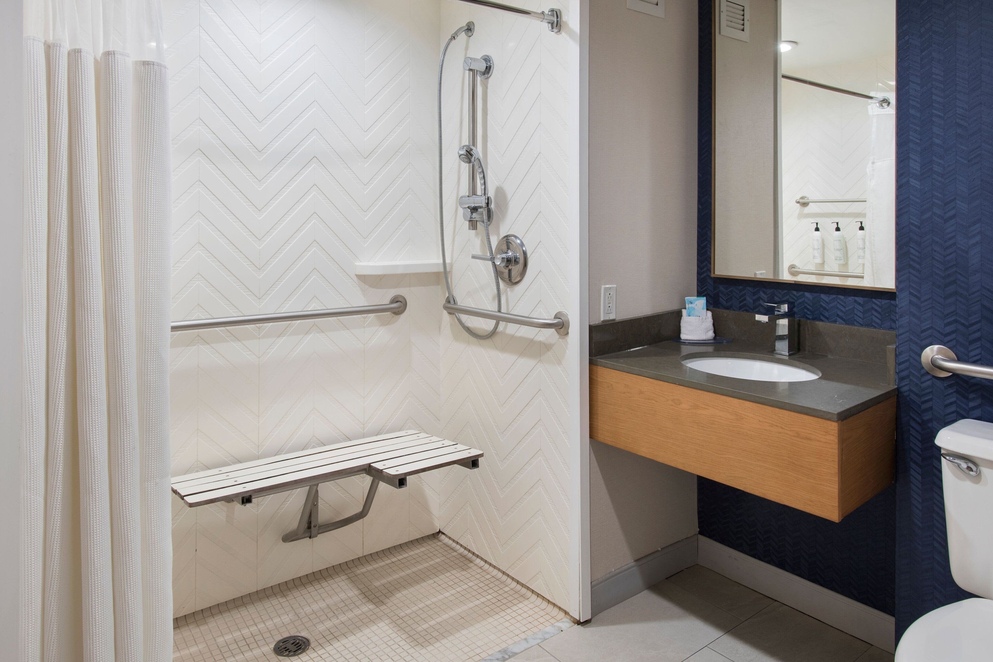 designer toiletries, hair dryer, towels