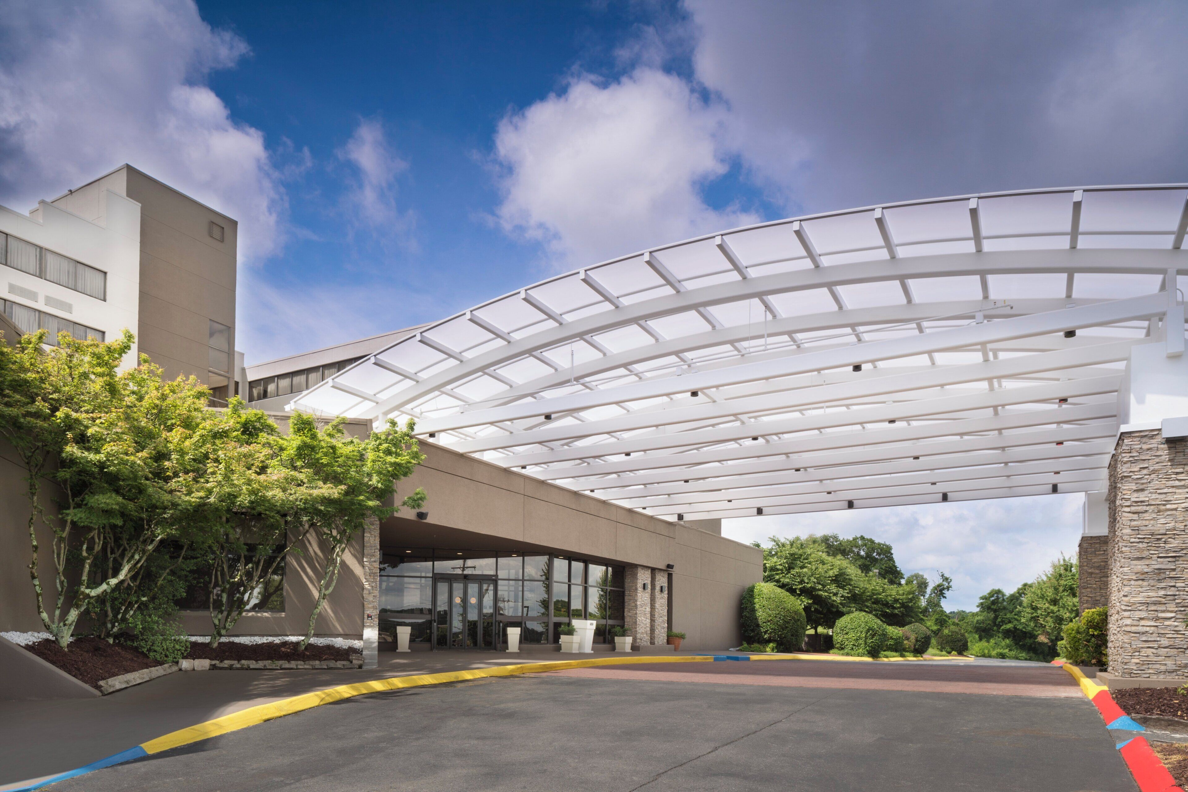 A modern building with a covered entrance and a clear sky.