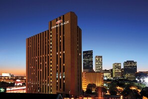 A tall hotel building with a prominent sign at the top. - Crowne Plaza Houston Med Ctr-Galleria Area by IHG (Houston)