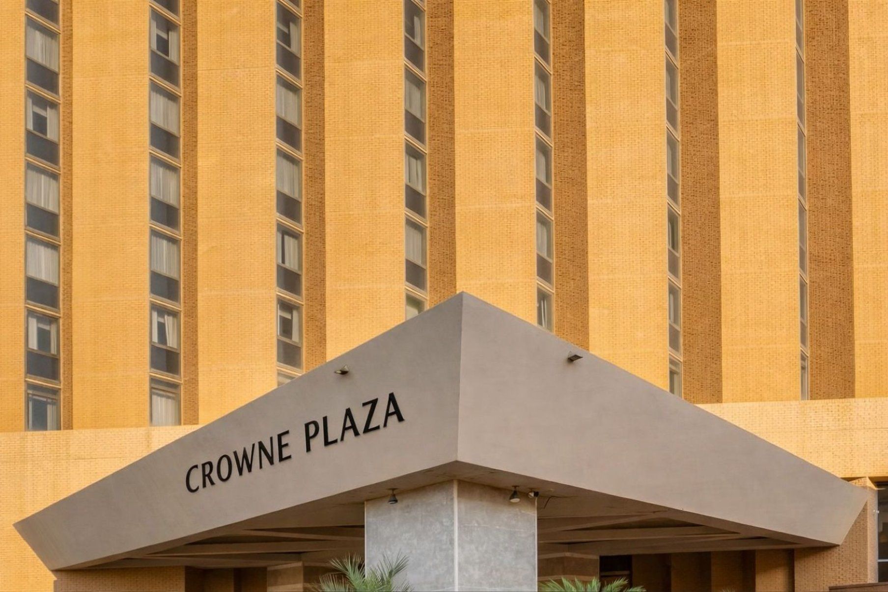 A building with a sign reading 'CROWNE PLAZA' at the entrance.