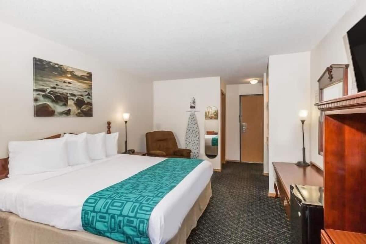 Premium bedding, desk, laptop workspace, blackout drapes