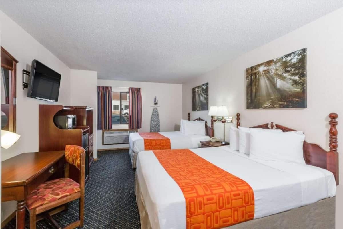 Premium bedding, desk, laptop workspace, blackout drapes