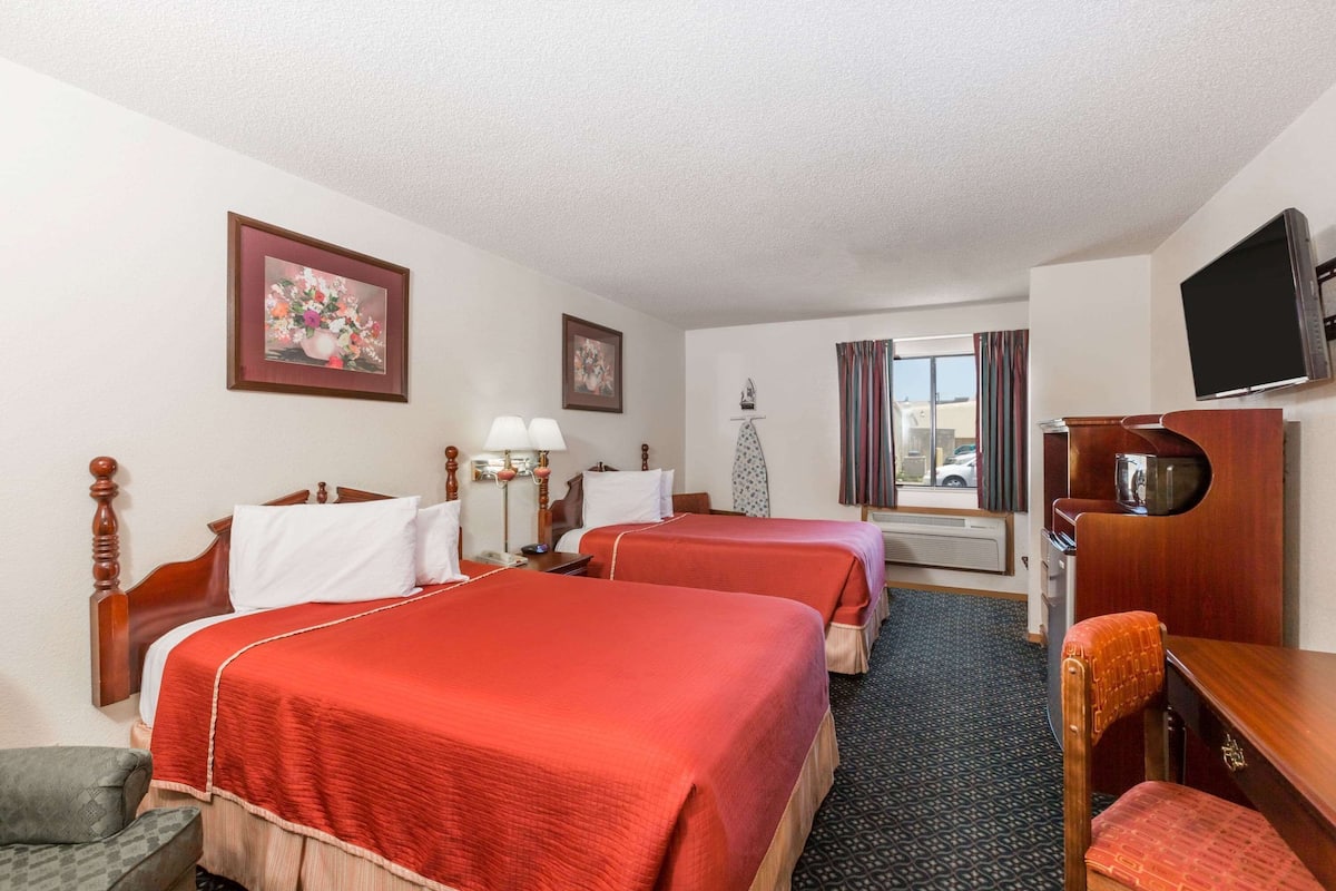 Premium bedding, desk, laptop workspace, blackout drapes
