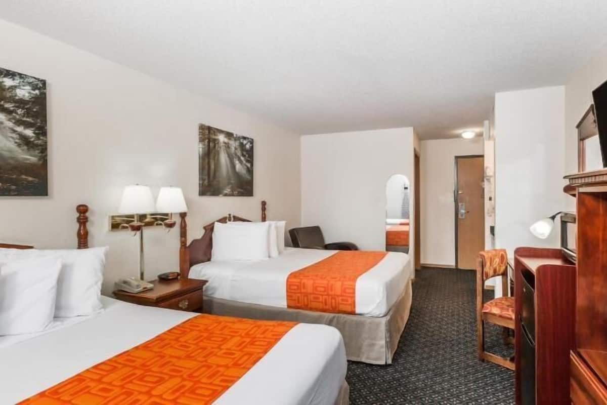 Premium bedding, desk, laptop workspace, blackout drapes