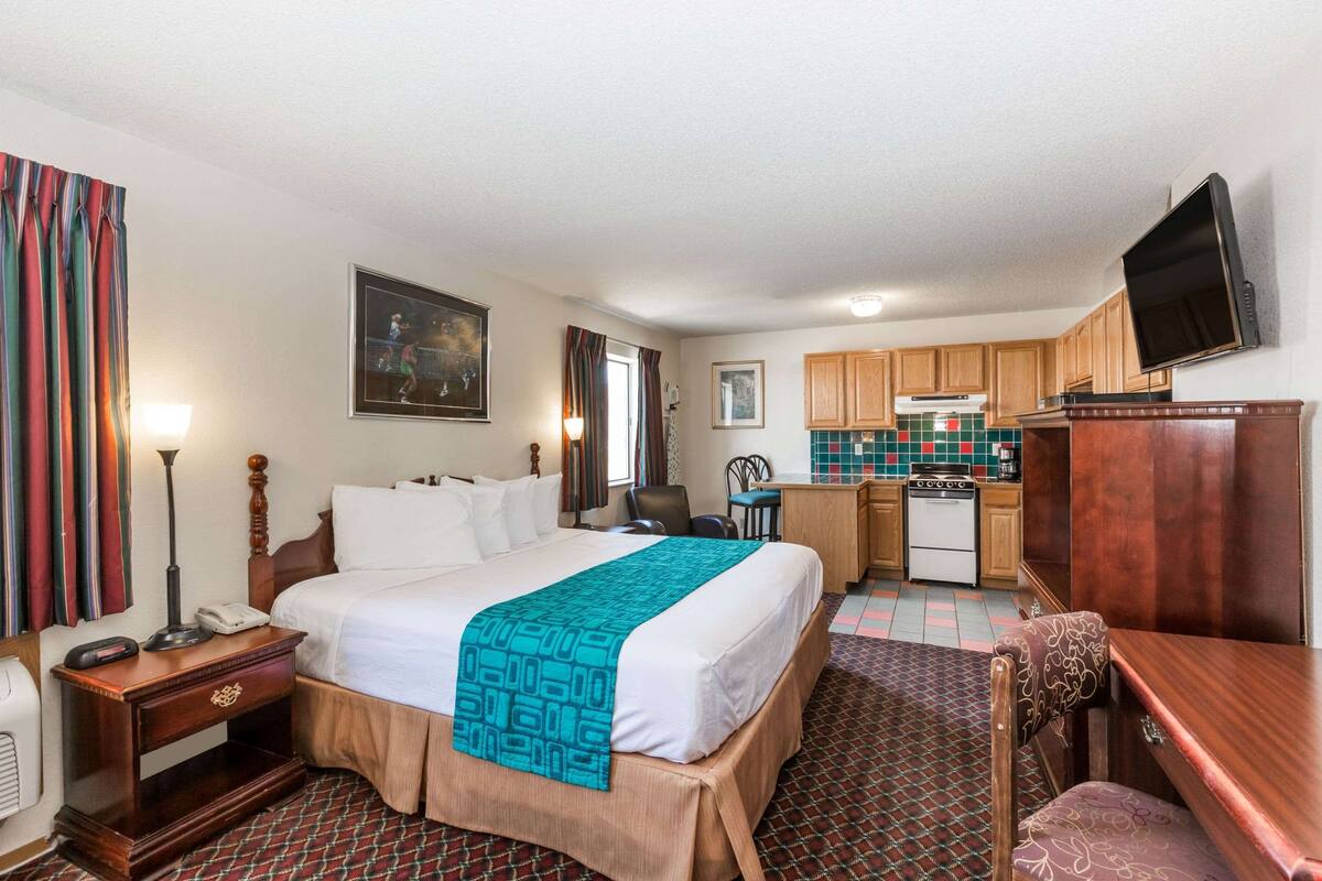 Premium bedding, desk, laptop workspace, blackout drapes