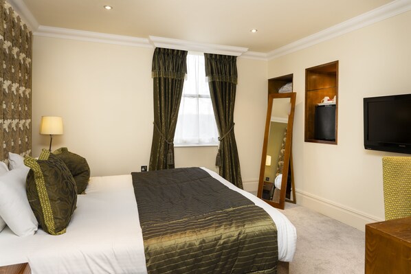 A hotel room with a large bed, a flat-screen TV, a mirror, and a window with curtains. - Ringwood Hall Hotel & Spa, BW Signature Collection (Chesterfield)